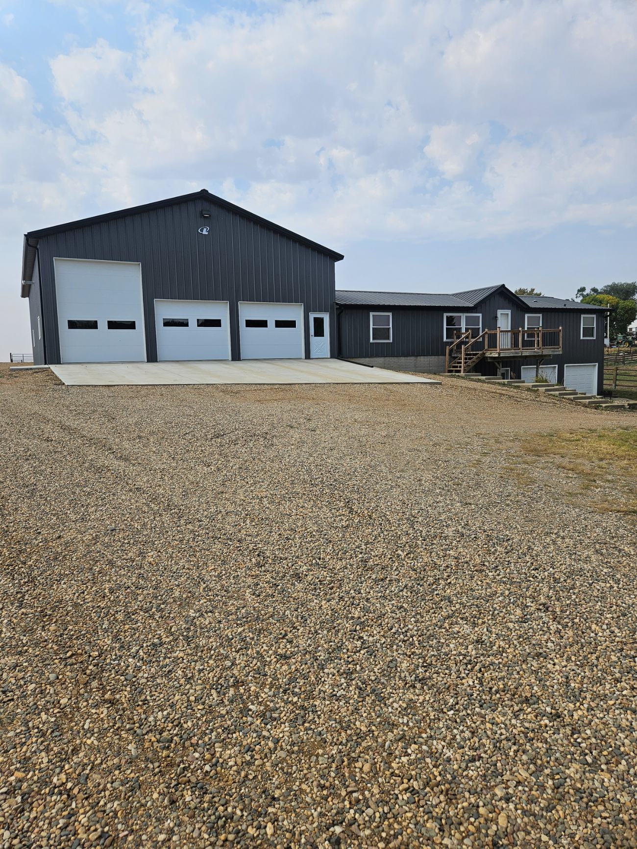 Grey and black post-frame hobby building by Hoksbergen & De Stigter